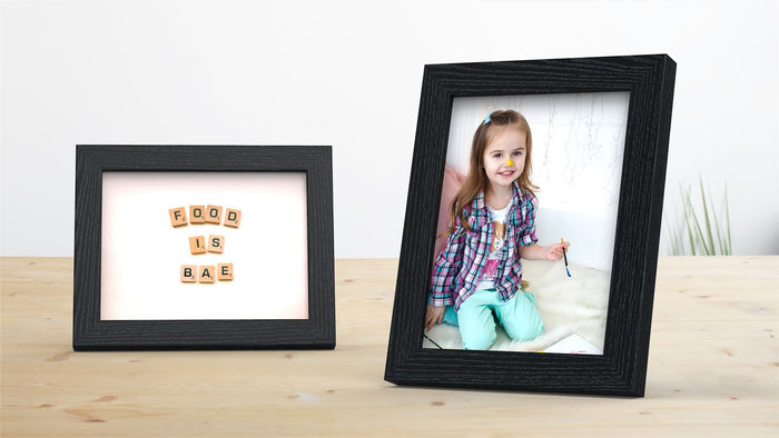 Blok Range black picture and poster frame displaying a fun message and a smiling girl with art supplies.