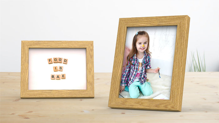 Blok Range oak picture poster frame displaying a child's photo and a playful quote about food.