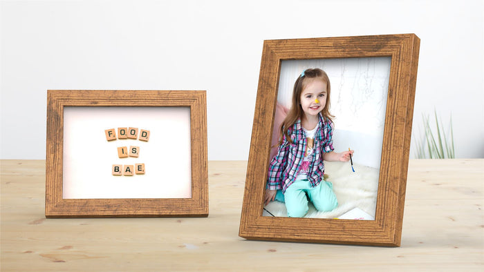 Rustic picture and poster frame showcasing a photo of a child and a decorative scrabble frame.