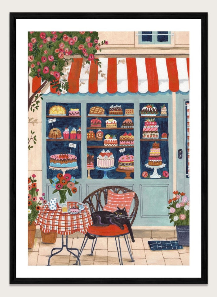 Illustration of a bakery with a cat sitting on a chair outside. Bakery Cat Cafe by Caroline Bonne Müller is a colorful bakery art print featuring cat illustration, pastry shop window, floral details, and modern aesthetic cafe scene.