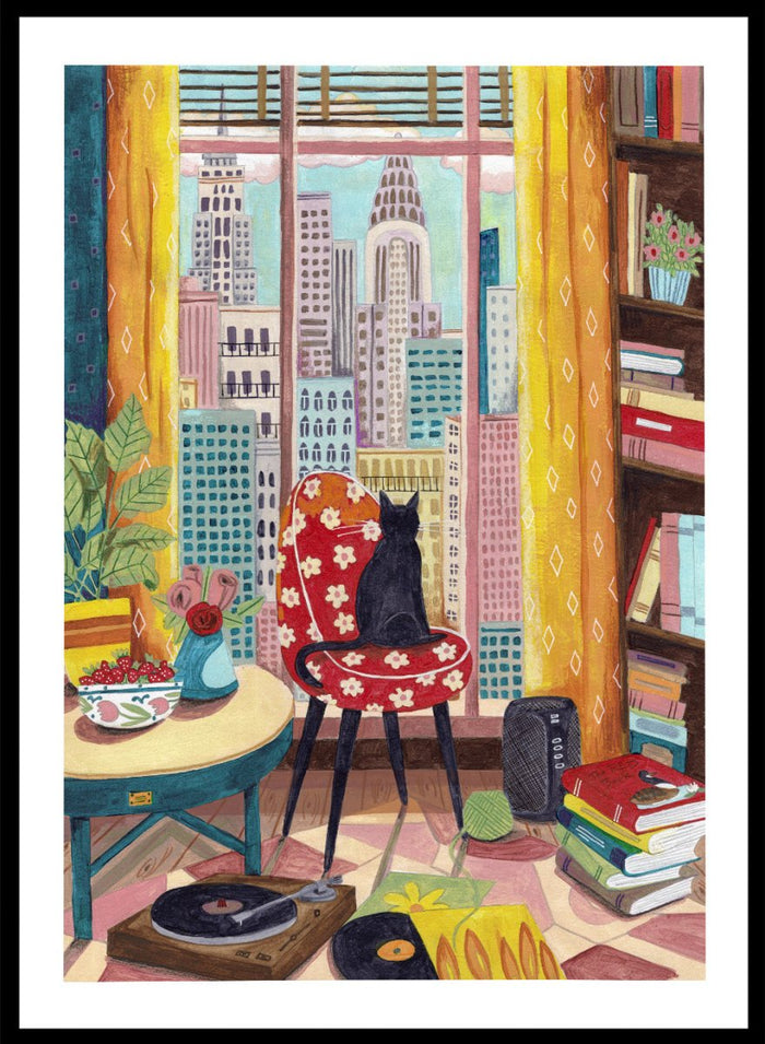 Colorful interior scene with a cat on a chair, books, and cityscape view. Black Cat City View by Caroline Bonne Müller is a fine art print and wall poster of a black cat by a window with city skyline and colorful interior.