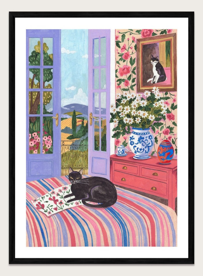 Cat lounging on a striped bed with a view of a garden through open doors, surrounded by flowers and decorative items. Black Cat on Bed French Doors Garden View by Caroline Bonne Müller is a colorful interior art print featuring cat illustration, floral room, and scenic garden view in a modern aesthetic style.
