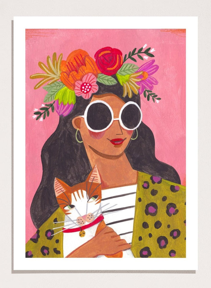 Illustration of a woman with a floral headpiece and sunglasses on a pink background. Cat Lady by Caroline Bonne Müller is a fine art print and wall poster of a woman holding a cat with bold color, floral crown, and modern aesthetic style.
