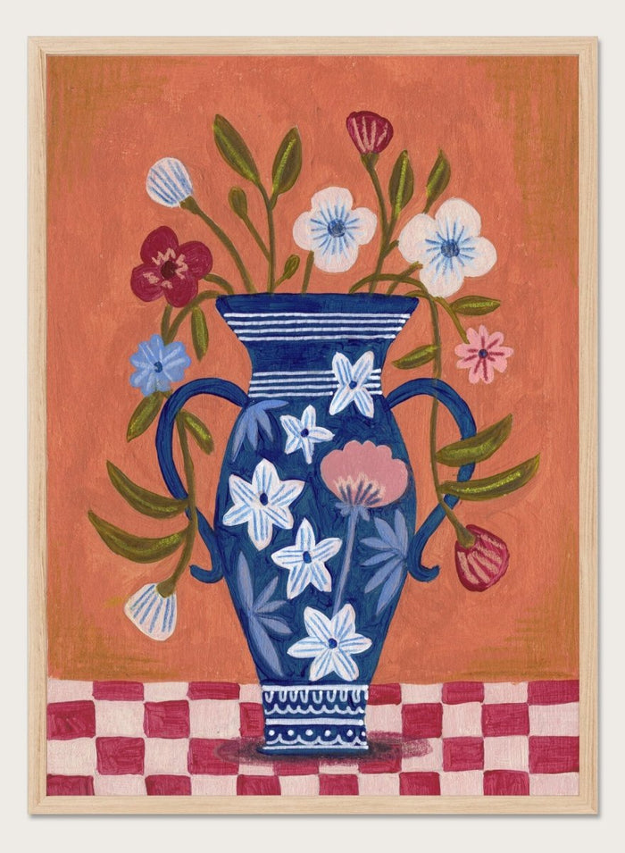 Decorative painting of a blue vase with floral patterns on a checkered floor against an orange wall. Folk Art Flower Vase by Caroline Bonne Müller is a fine art print and wall poster featuring a blue floral vase with colorful flowers on a checkered table.