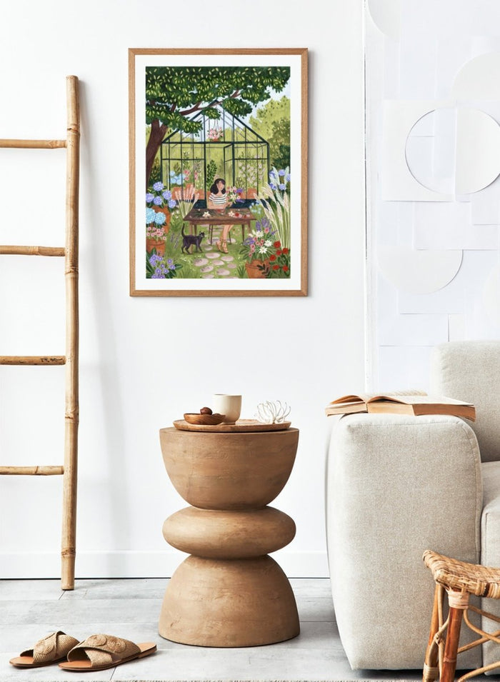 Garden Flower Arranging by Caroline Bonne Müller is a floral garden art print featuring greenhouse, woman arranging flowers, cat illustration, and modern aesthetic botanical scene.