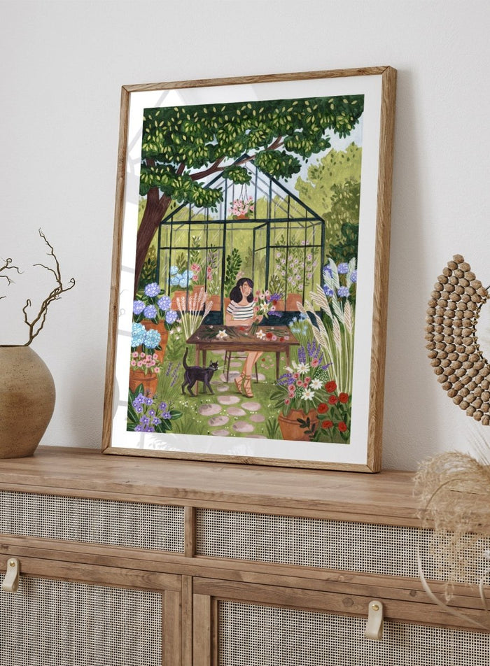 Garden Flower Arranging by Caroline Bonne Müller is a floral garden art print featuring greenhouse, woman arranging flowers, cat illustration, and modern aesthetic botanical scene.
