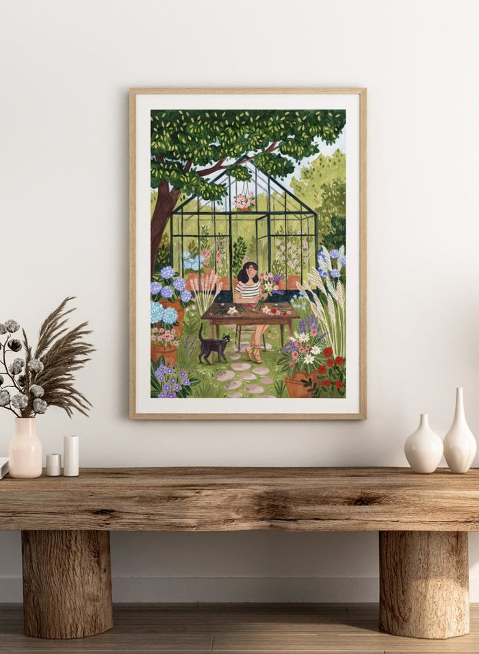 Garden Flower Arranging by Caroline Bonne Müller is a floral garden art print featuring greenhouse, woman arranging flowers, cat illustration, and modern aesthetic botanical scene.