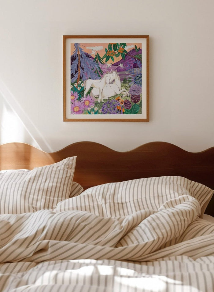 Framed artwork of two horses in a colorful forest scene with flowers and mountains. Horses in the Mountains by Caroline Bonne Müller is a fine art print and wall poster featuring two white horses surrounded by colorful flowers in a mountain landscape.