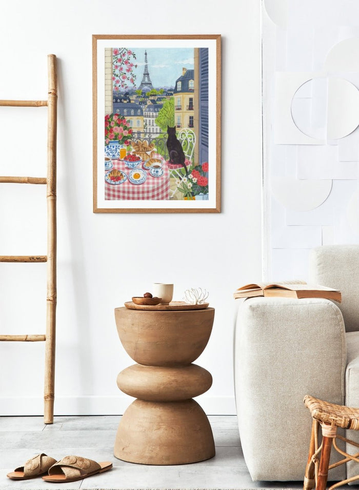 Parisian scene with a cat, table setting, and Eiffel Tower view. Paris Balcony Breakfast by Caroline Bonne Müller is a colorful Paris art print featuring Eiffel Tower view, breakfast table, cat illustration, and modern aesthetic city scene.