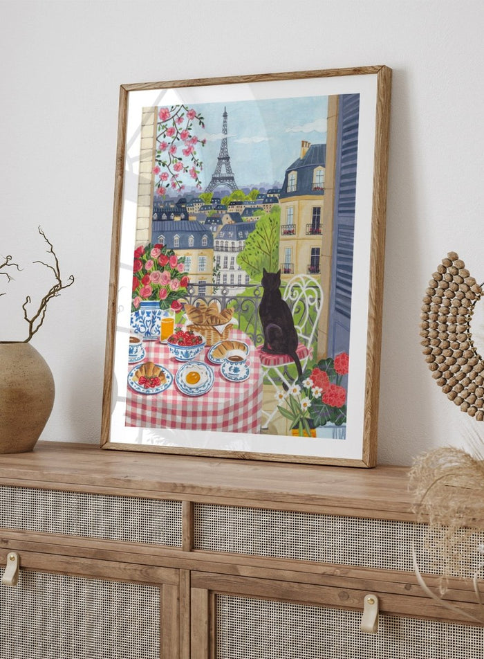 Parisian scene with a cat, table setting, and Eiffel Tower view. Paris Balcony Breakfast by Caroline Bonne Müller is a colorful Paris art print featuring Eiffel Tower view, breakfast table, cat illustration, and modern aesthetic city scene.