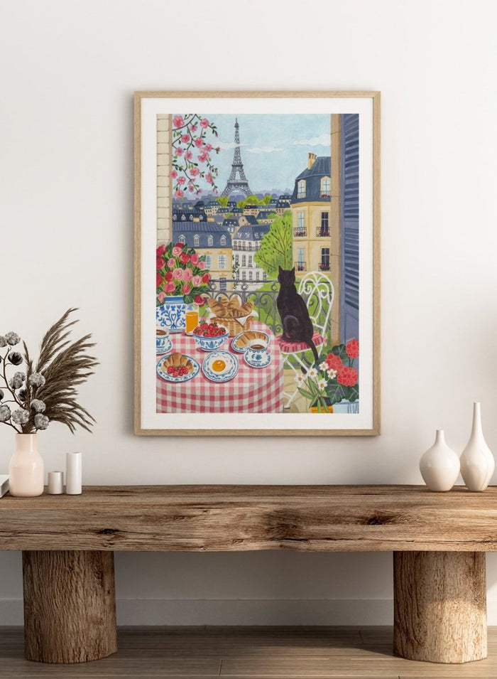 Parisian scene with a cat, table setting, and Eiffel Tower view. Paris Balcony Breakfast by Caroline Bonne Müller is a colorful Paris art print featuring Eiffel Tower view, breakfast table, cat illustration, and modern aesthetic city scene.