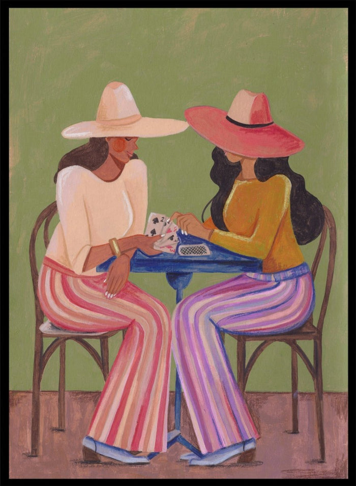 Two women playing cards at a table with colorful clothing and hats against a green background. Stylish Women Play Cards by Caroline Bonne Müller is a fine art print and wall poster featuring two fashionable women playing cards at a table.