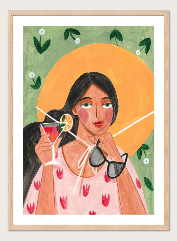Illustration of a woman holding a cocktail and sunglasses with a sun and foliage background. Summer Woman Cocktail Hat by Caroline Bonne Müller is a fine art print and wall poster featuring a woman holding a cocktail with a bold yellow hat and bright summer colors.