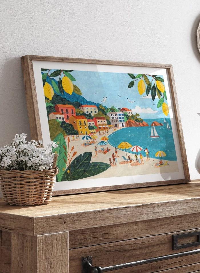 Framed artwork of a beach scene with people, umbrellas, and sailboats. Sunny Lemon Coastal Town by Caroline Bonne Müller is a colorful coastal art print featuring beach scene, seaside town, lemon branches, and modern aesthetic summer illustration.
