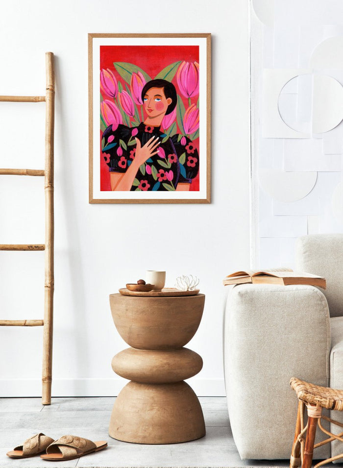 Illustration of a woman with floral dress and pink tulips on a red background. Woman portrait art print surrounded by pink tulips on a red background by Caroline Bonne Müller. Colorful floral illustration wall poster, officially licensed.
