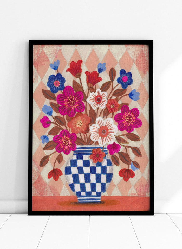 Decorative quilt with a blue and white checkered vase and colorful flowers on a patterned background. Vibrant Checked Vase Flowers by Caroline Bonne Müller is a fine art print and wall poster featuring colorful flowers in a blue checkered vase.