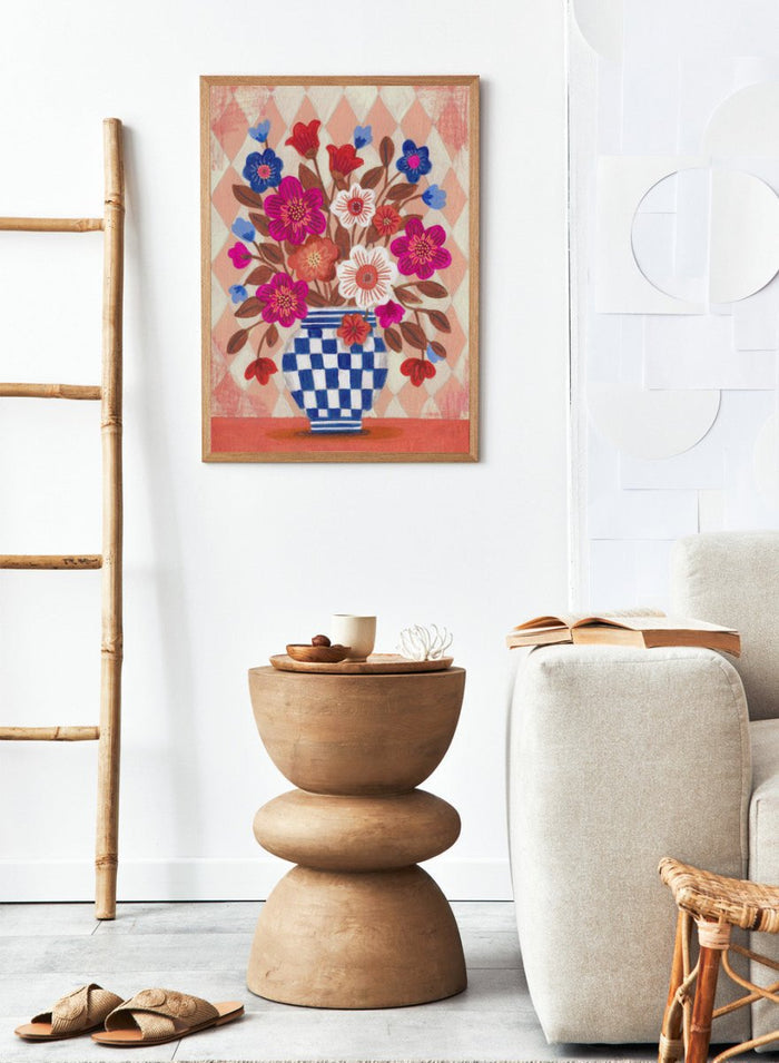Decorative quilt with a blue and white checkered vase and colorful flowers on a patterned background. Vibrant Checked Vase Flowers by Caroline Bonne Müller is a fine art print and wall poster featuring colorful flowers in a blue checkered vase.