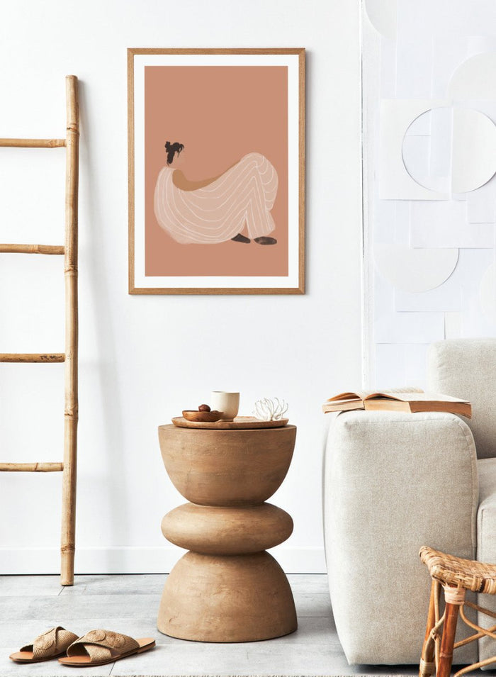 Warm minimalist woman art print by Casa Cartissi featuring soft peach tones and relaxed figure illustration. Contemporary modern wall poster with calm, sunlit aesthetic.