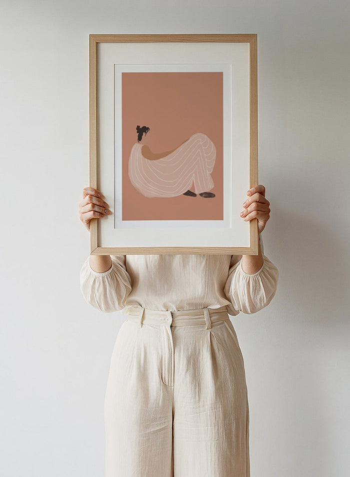 Warm minimalist woman art print by Casa Cartissi featuring soft peach tones and relaxed figure illustration. Contemporary modern wall poster with calm, sunlit aesthetic.
