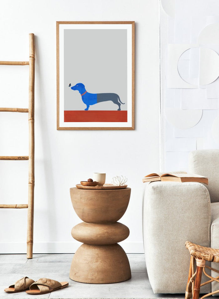 Blue dachshund wall art print by Casa Cartissi featuring a modern butterfly illustration. Contemporary minimalist animal poster with textured shapes and warm color palette.