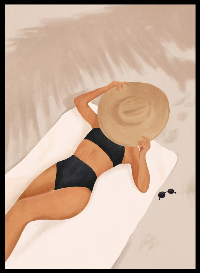 Woman in black bikini and straw hat lying on a towel with sunglasses nearby. Beach Day Relaxation by City Art is a modern beach art print featuring a woman in a black swimsuit, oversized sun hat, soft sand, and warm neutral tones.