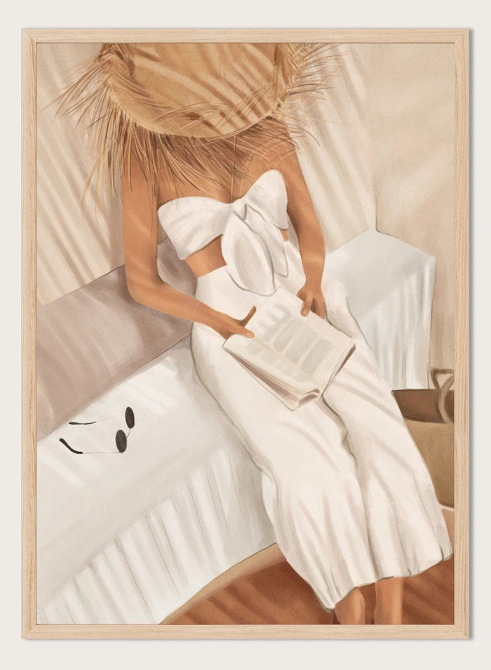 Woman in a white dress holding a clutch, sitting on a couch with a neutral background. Chic Summer Reading by City Art features a woman reading in a sunlit bedroom, bringing warm neutrals, relaxed interiors, and organic summer style home.