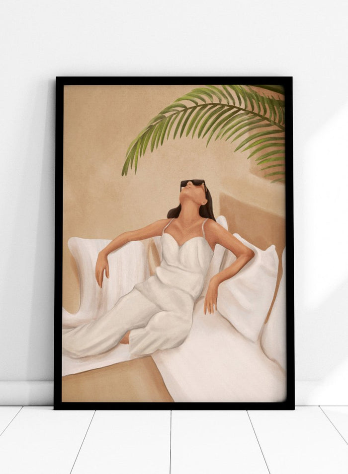 Woman in a white dress lying on a couch with a palm leaf above, against a beige wall. Chic Summer Serenity by City Art features a woman reclining among cushions and palm leaves, bringing warm summer tones and relaxed interiors to your home.