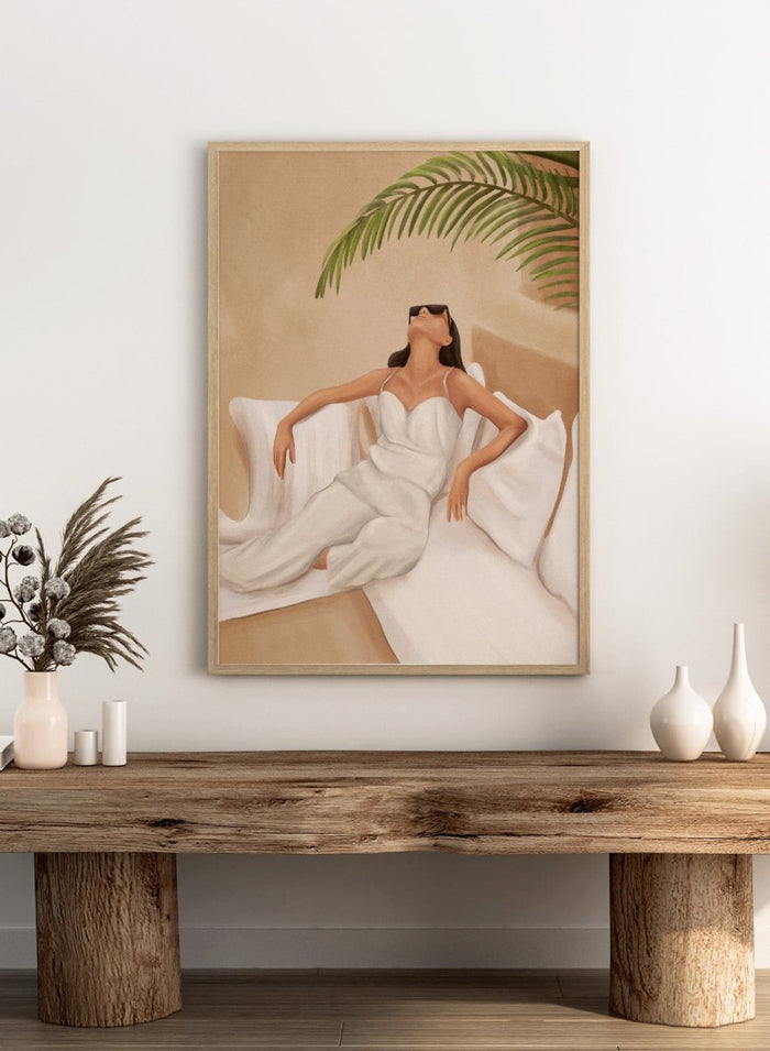 Woman in a white dress lying on a couch with a palm leaf above, against a beige wall. Chic Summer Serenity by City Art features a woman reclining among cushions and palm leaves, bringing warm summer tones and relaxed interiors to your home.