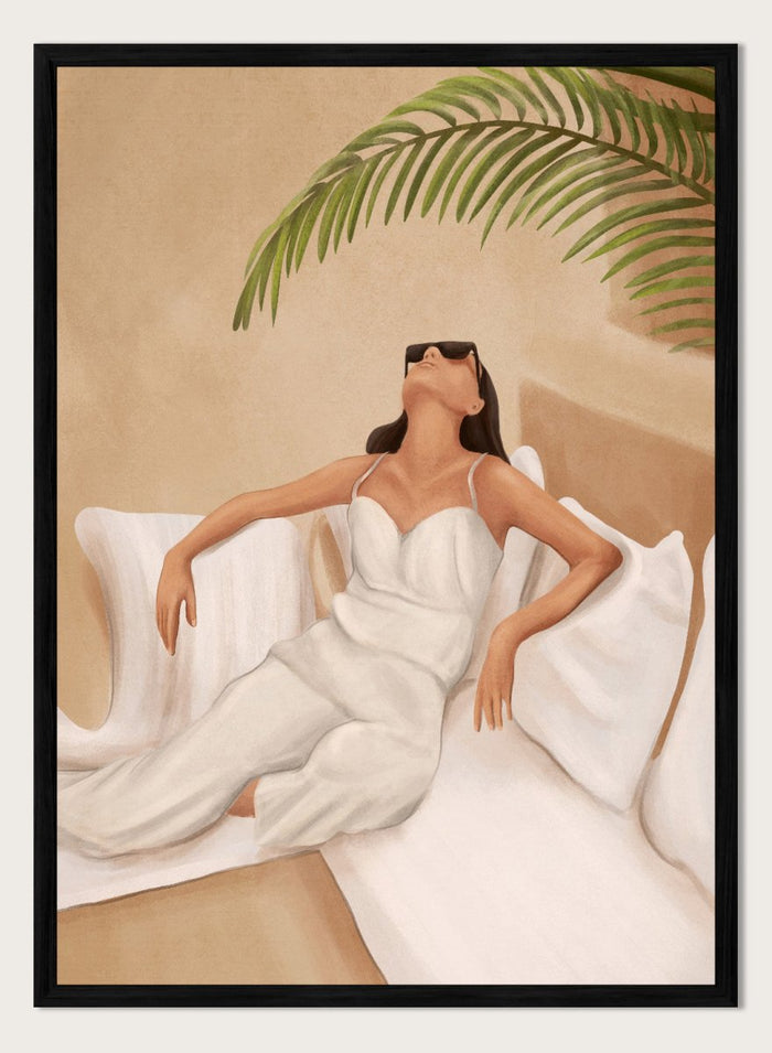 Woman in a white dress lying on a couch with a palm leaf above, against a beige wall. Chic Summer Serenity by City Art features a woman reclining among cushions and palm leaves, bringing warm summer tones and relaxed interiors to your home.