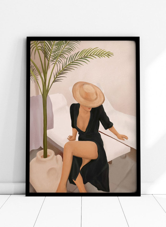 Woman in a black dress and straw hat sitting on a white chair with a plant nearby. Elegant Woman Sun Hat by City Art is a modern figurative art print featuring a stylish woman, tropical greenery, warm neutrals, and relaxed summer living.