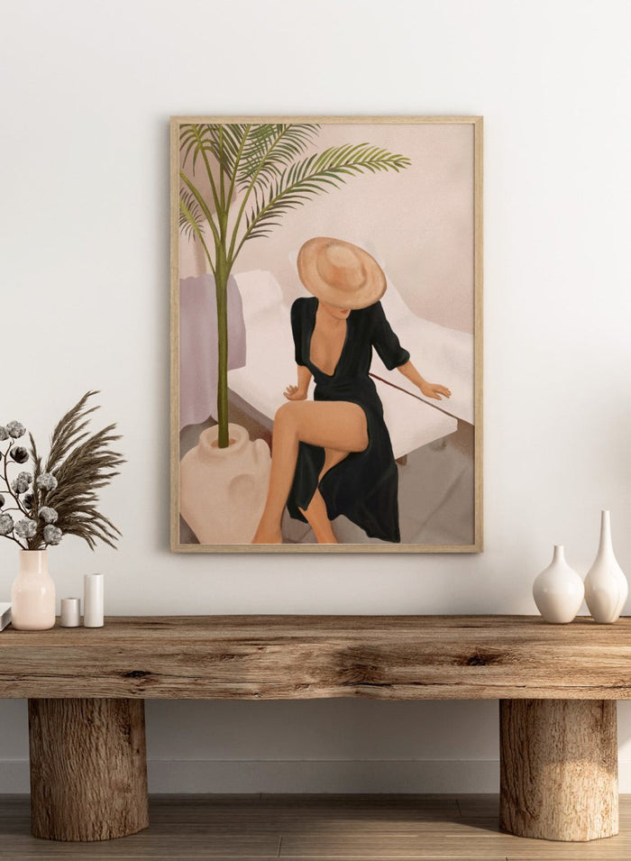 Woman in a black dress and straw hat sitting on a white chair with a plant nearby. Elegant Woman Sun Hat by City Art is a modern figurative art print featuring a stylish woman, tropical greenery, warm neutrals, and relaxed summer living.