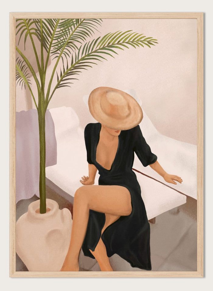 Woman in a black dress and straw hat sitting on a white chair with a plant nearby. Elegant Woman Sun Hat by City Art is a modern figurative art print featuring a stylish woman, tropical greenery, warm neutrals, and relaxed summer living.