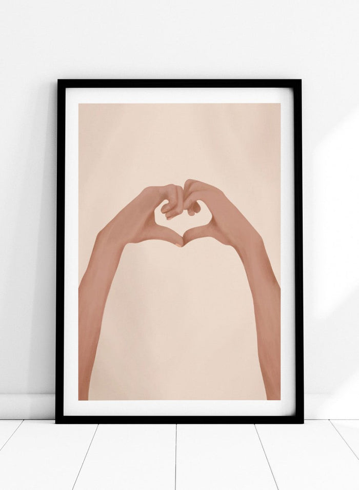 Framed artwork of hands making a heart shape on a beige background. Heartfelt Hands by City Art is a modern figurative art print featuring hands forming a heart. A love-inspired wall poster from the It’s All Love collection.