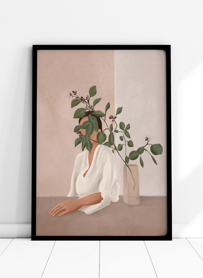 Artistic depiction of a woman with green leaves covering her face, sitting next to a vase on a table. Serene Botanical Woman by City Art features a woman surrounded by greenery, bringing soft botanical style and modern neutral wall art to your home.