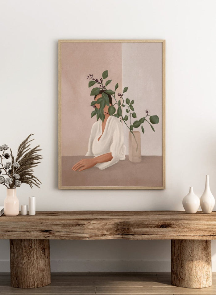 Artistic depiction of a woman with green leaves covering her face, sitting next to a vase on a table. Serene Botanical Woman by City Art features a woman surrounded by greenery, bringing soft botanical style and modern neutral wall art to your home.