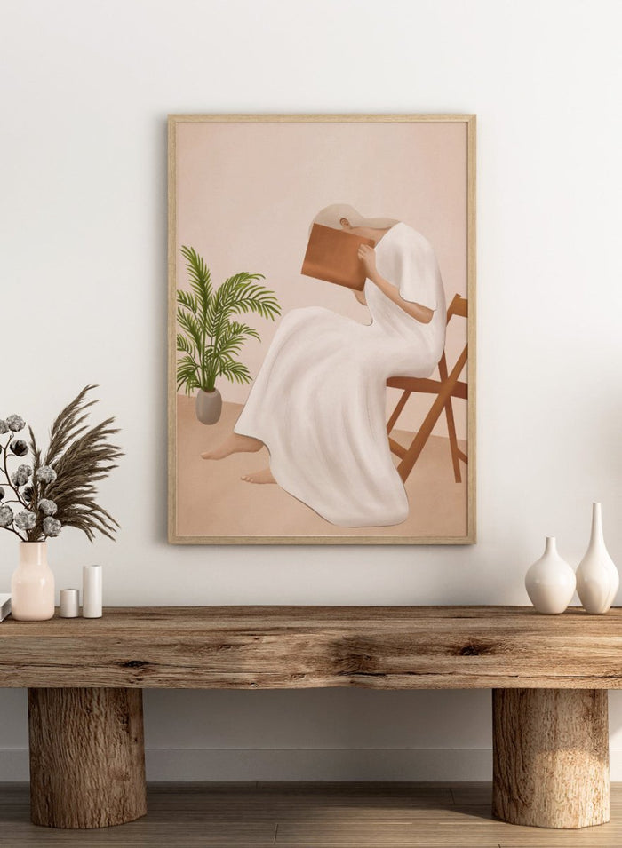 Person in a white dress holding a book, sitting on a chair with a plant nearby. Serene Woman Reading by City Art is a minimalist figurative art print featuring a woman reading in a flowing white dress with warm neutral tones and botanical details.