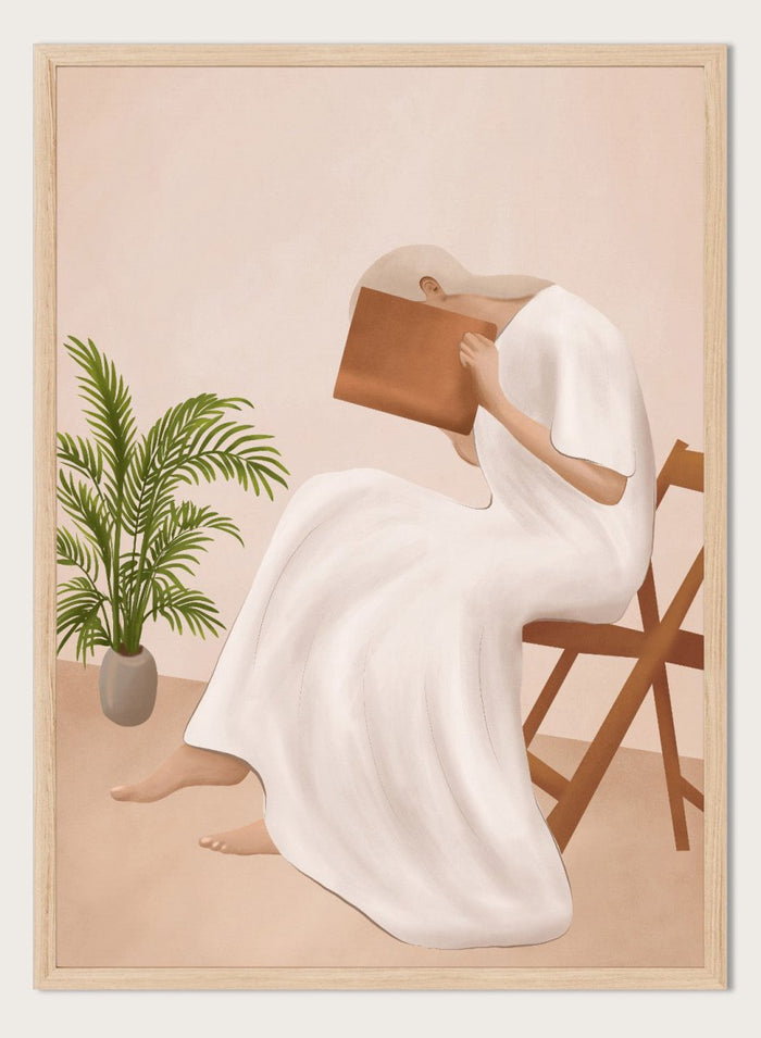 Person in a white dress holding a book, sitting on a chair with a plant nearby. Serene Woman Reading by City Art is a minimalist figurative art print featuring a woman reading in a flowing white dress with warm neutral tones and botanical details.