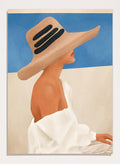Woman wearing a large straw hat with black bands against a blue sky. Summer Hat Profile by City Art features a woman beneath a straw sun hat against a blue sky, bringing coastal style and summer-inspired portrait art into the home.
