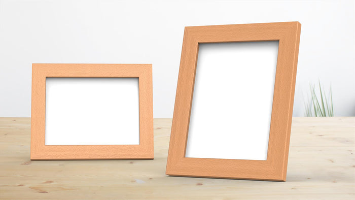 Two beech picture frames on a wooden table, ideal for displaying photos and prints in any style.