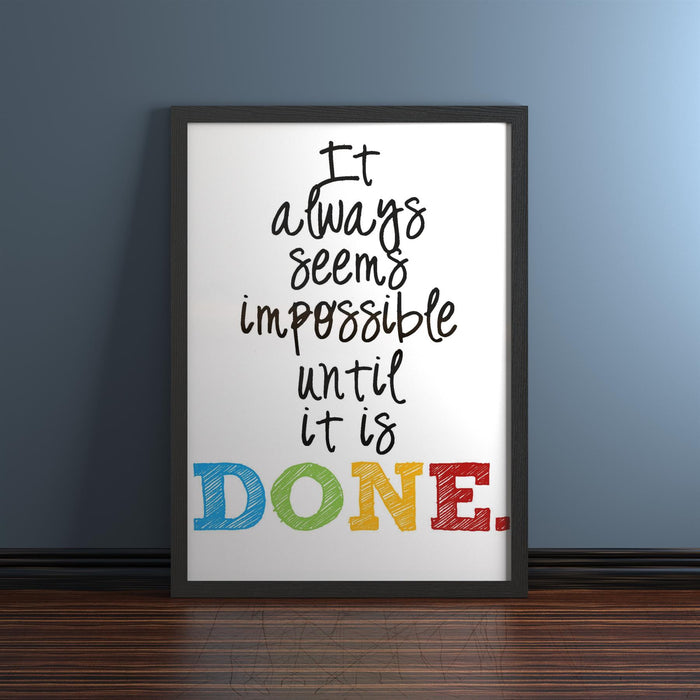 Inspiring quote framed in a black picture frame for photos and posters, placed on a wooden floor.