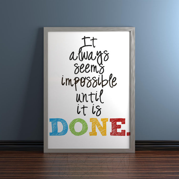 Chrome picture frame displaying motivational quote: 'It always seems impossible until it is DONE.'