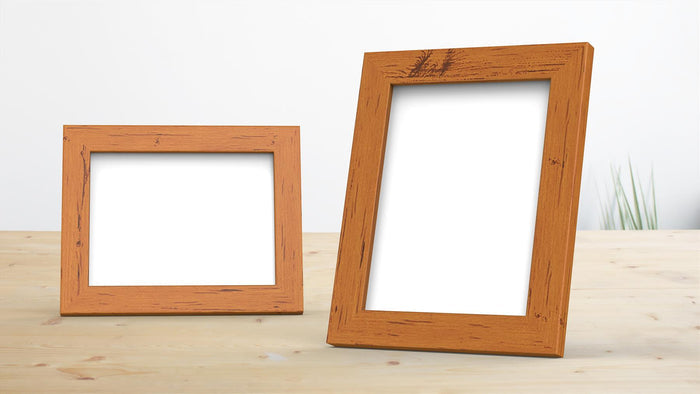 Dark teak picture frame set on a wooden table, showcasing two empty frames in various sizes.