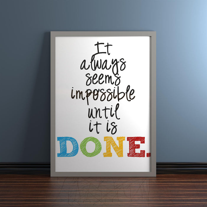 Motivational quote in a silver picture frame, stating 'It always seems impossible until it is DONE.'