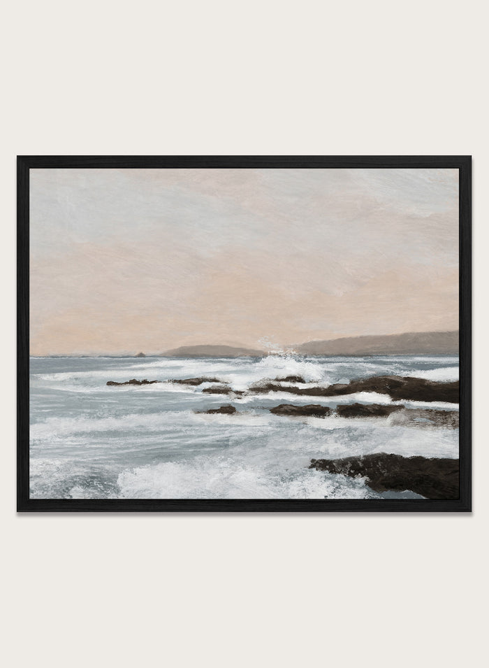 Shop Constantine Bay by Dan Hobday, a contemporary coastal wall art print with rocky shoreline, ocean waves, soft blue water, and warm beige-gray tones.