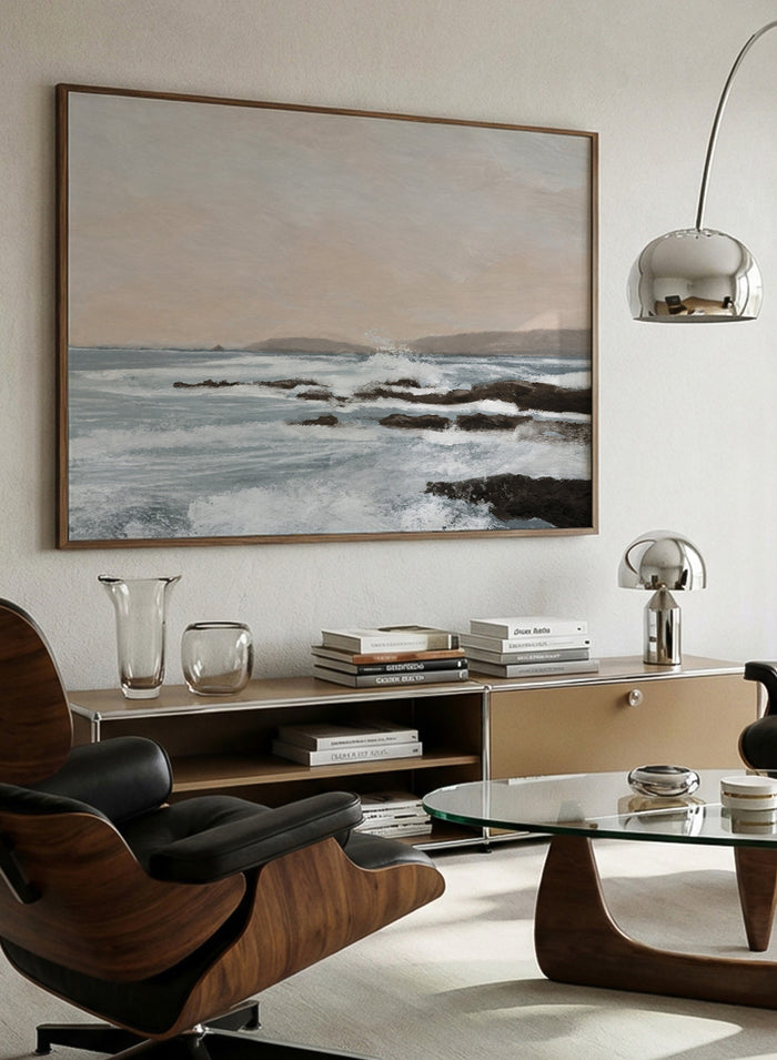 Shop Constantine Bay by Dan Hobday, a contemporary coastal wall art print with rocky shoreline, ocean waves, soft blue water, and warm beige-gray tones.