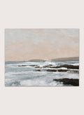 Shop Constantine Bay by Dan Hobday, a contemporary coastal wall art print with rocky shoreline, ocean waves, soft blue water, and warm beige-gray tones.