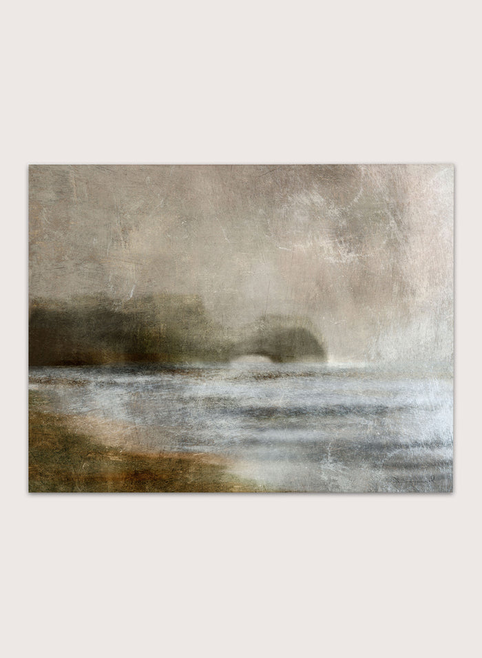A framed abstract landscape art print featuring textured waves and a distant rocky shoreline in muted beige, gray, brown, and white tones. Shop Dusk by Dan Hobday, a moody landscape art print featuring misty water, low hills, earthy neutral toned nature, and soft layered brush texture.