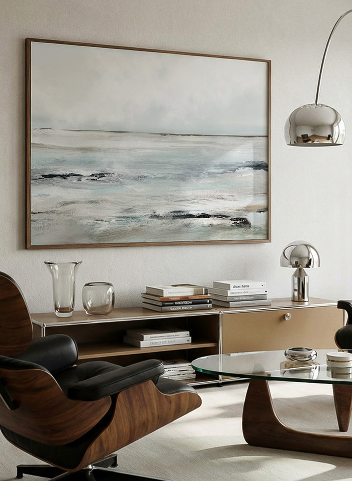 Shop Sandy Bay by Dan Hobday, a coastal landscape art print featuring soft blue-gray water, pale sky, textured shoreline, and layered neutral brushwork.