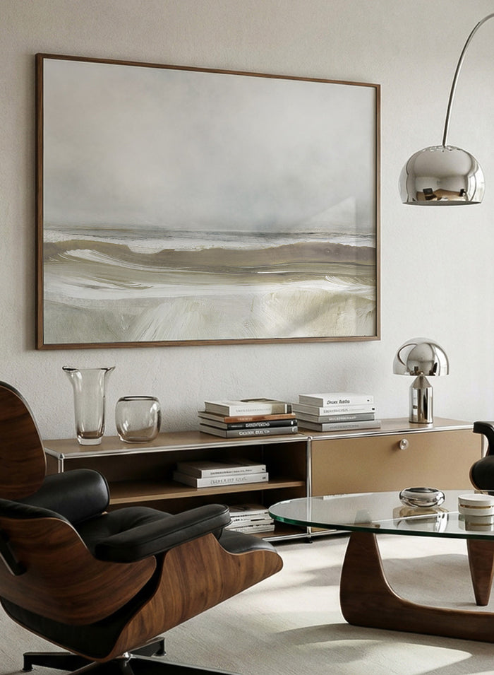 A framed abstract landscape art print depicting a misty beach scene with soft beige, gray, and white tones. Shop Sea Air by Dan Hobday, a contemporary coastal wall art print featuring ocean waves, a soft horizon, misty gray tones, and warm taupe brushwork.