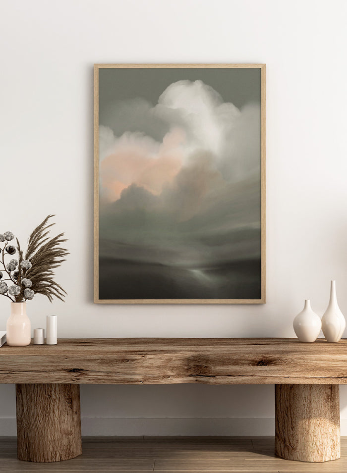 Shop Tempesta by Dan Hobday, a dramatic landscape wall art print featuring storm clouds, moody skies, soft gray-green tones, and a subtle peach glow.